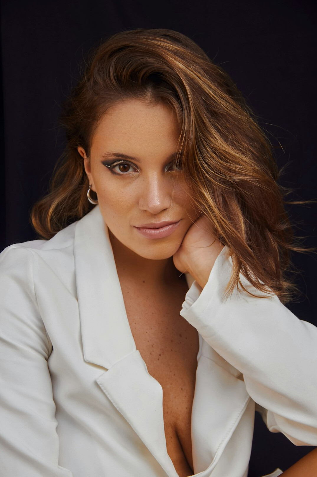 Studio portrait of a woman in a blazer smiling